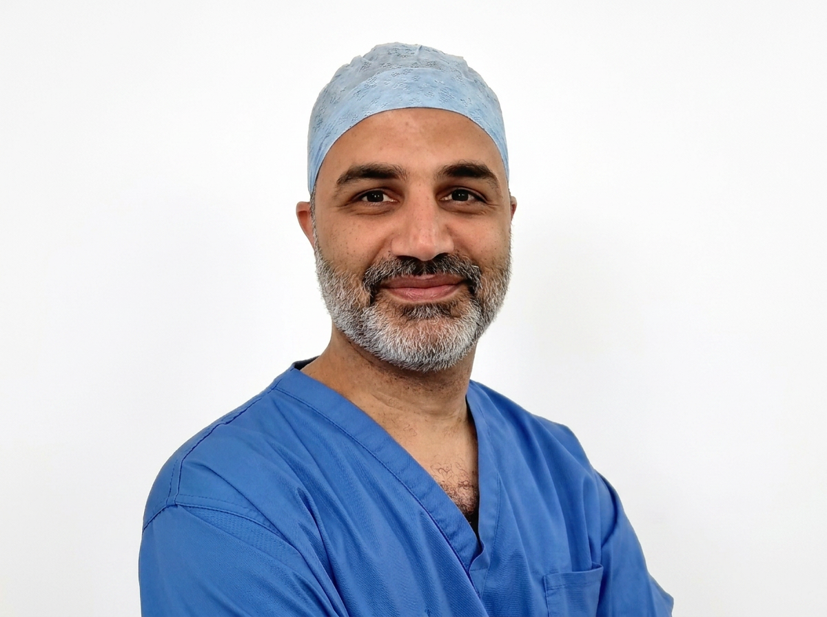 Mr Aimen Amer in surgical scrubs